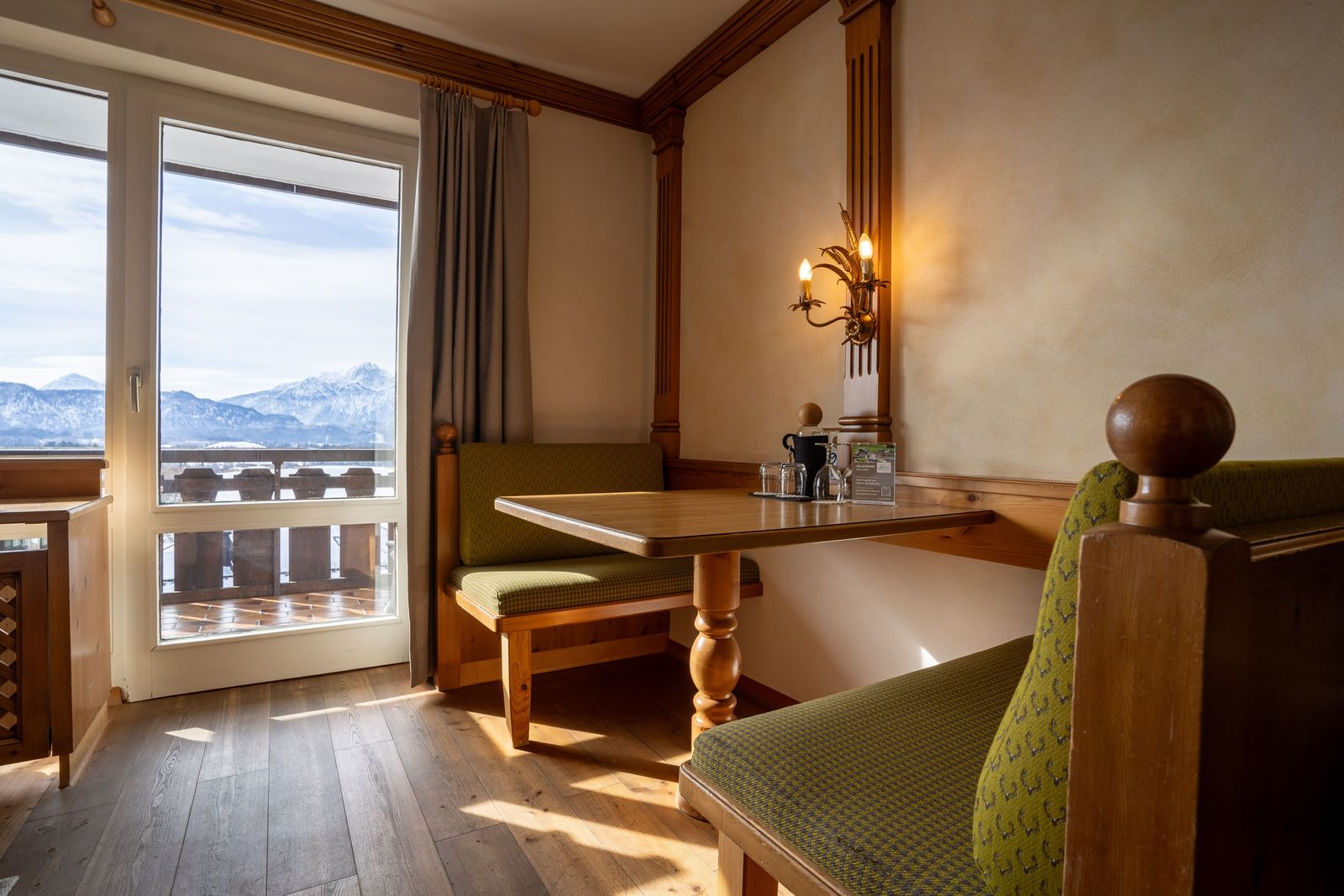 Single room Bio-Balance with seating area and view over the south-facing balcony to Lake Hopfensee and the mountains