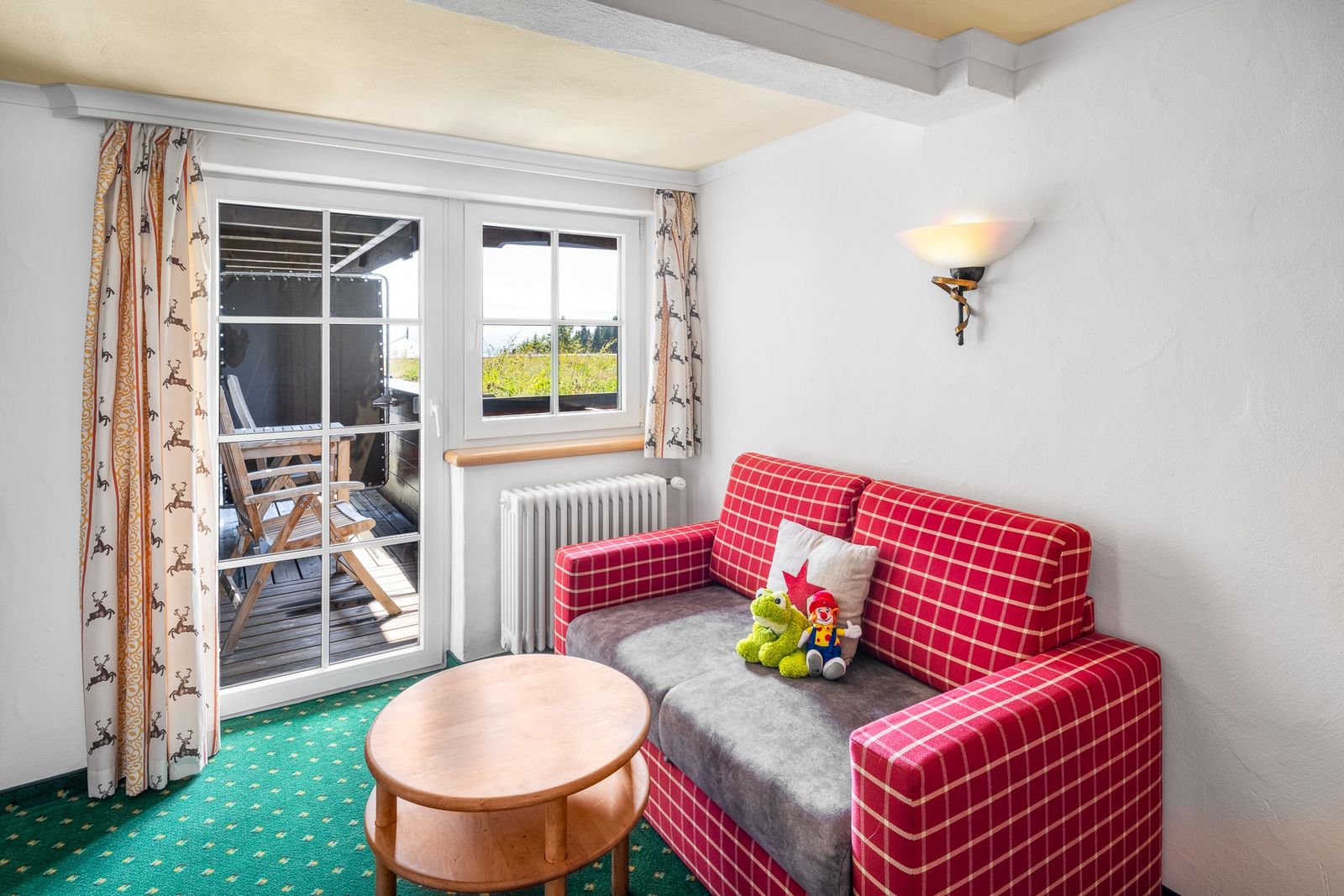 Kinderhotel Allgäuer Berghof – Wohnzimmer Familiensuite Deckelschneck mit Blick auf die Allgäuer Alpen