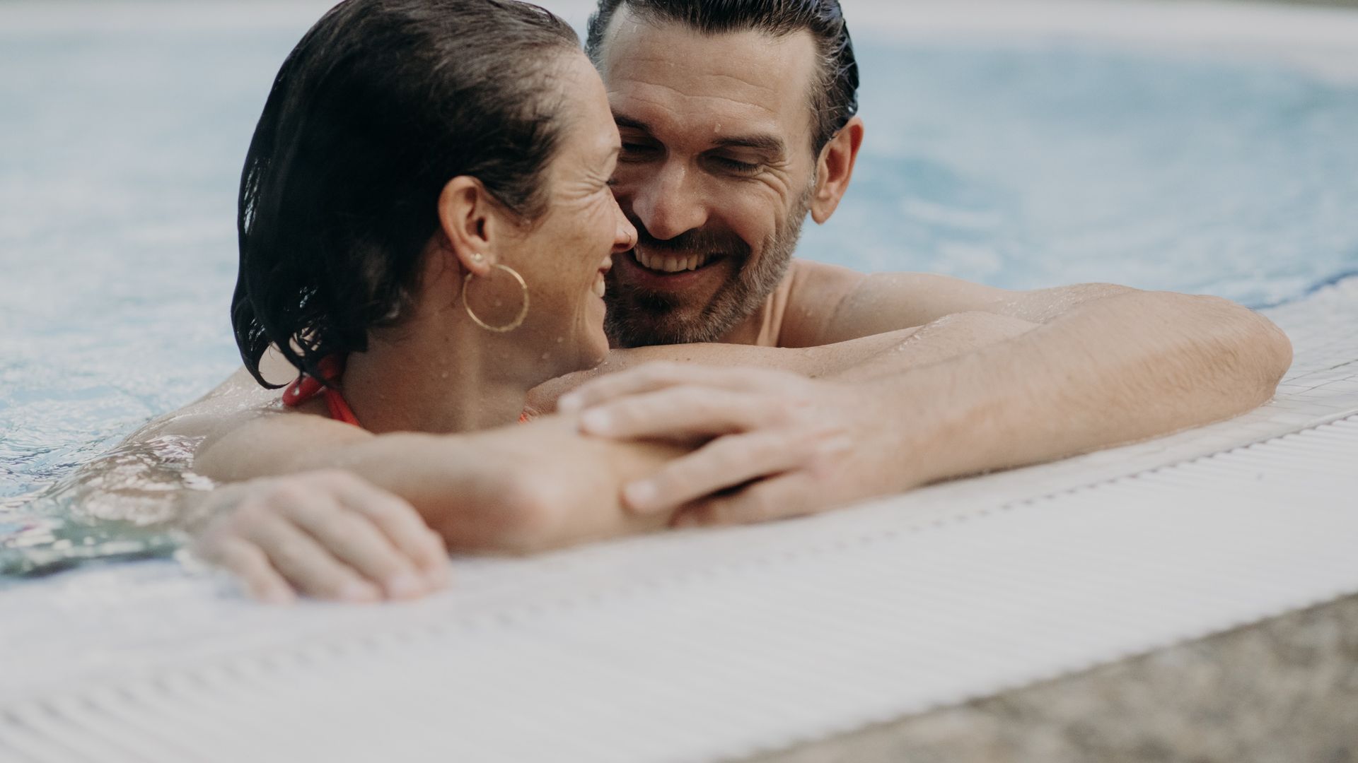 Paar im Außenpool des Hotel Sonngastein – Wellness, Entspannung und gemeinsame Auszeit in Gastein.