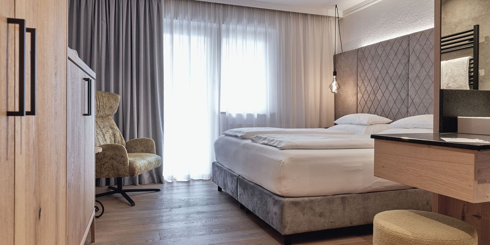 Helles Licht, feine Stoffe, stilvolle Details: Das Doppelzimmer der HOCHKÖNIGIN in Maria Alm steht für modernen Komfort und edles Design.