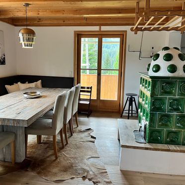 Dining area with tiled oven, Almhütte Sunset, Glödnitz, Carinthia , Austria
